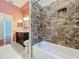Bathroom features a tub and shower combination with decorative tile surround at 5489 Glen Oak Place, Sanford, FL 32771