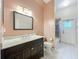 Bathroom with a dark wood vanity, marble countertop, and shower at 5489 Glen Oak Place, Sanford, FL 32771
