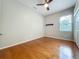 An inviting bedroom with gleaming hardwood floors, ceiling fan, natural light, and neutral wall color at 5489 Glen Oak Place, Sanford, FL 32771