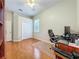 Office space with hardwood floors, ceiling fan, and large windows for natural light at 5489 Glen Oak Place, Sanford, FL 32771