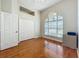 Bright bedroom features a vaulted ceiling, arched window, and hardwood flooring at 5489 Glen Oak Place, Sanford, FL 32771