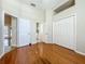 Bedroom with hardwood flooring, double closet, and ensuite bathroom access at 5489 Glen Oak Place, Sanford, FL 32771