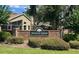 The Forest Glen community brick sign with lush landscaping and a glimpse of the surrounding homes at 5489 Glen Oak Place, Sanford, FL 32771