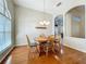 Charming dining room with archway, chandelier, wood floors, and a large arched window at 5489 Glen Oak Place, Sanford, FL 32771