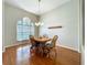 Bright dining room featuring a chandelier, wood floors, and a large window at 5489 Glen Oak Place, Sanford, FL 32771