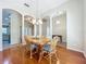Elegant dining area with wood table set, chandelier, and arched openings to other rooms at 5489 Glen Oak Place, Sanford, FL 32771