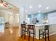 Kitchen featuring a breakfast bar with seating and a view into the foyer and stainless steel refrigerator at 5489 Glen Oak Place, Sanford, FL 32771