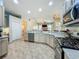 Spacious kitchen featuring stainless steel appliances, light countertops, ample cabinetry, and views into the living room at 5489 Glen Oak Place, Sanford, FL 32771