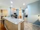 Kitchen featuring a breakfast bar with seating and a view into the dining area with a stainless steel refrigerator at 5489 Glen Oak Place, Sanford, FL 32771