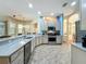 Spacious kitchen featuring stainless steel appliances, light countertops, ample cabinetry, and an eat-in breakfast bar at 5489 Glen Oak Place, Sanford, FL 32771