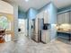 Kitchen featuring stainless steel refrigerator and views to the laundry room and breakfast nook with natural light at 5489 Glen Oak Place, Sanford, FL 32771