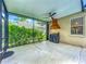 Covered lanai featuring a ceiling fan, grill, outdoor kitchen exhaust fan, and a view of the backyard at 5489 Glen Oak Place, Sanford, FL 32771