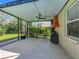 Covered lanai featuring a ceiling fan, grill, outdoor kitchen exhaust fan, and a view of the backyard at 5489 Glen Oak Place, Sanford, FL 32771