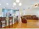 Open concept living room and kitchen area featuring hardwood floors, natural light, and ample seating at 5489 Glen Oak Place, Sanford, FL 32771