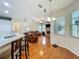 Open-concept living area with breakfast bar, hardwood floors, fireplace, and plentiful natural light at 5489 Glen Oak Place, Sanford, FL 32771
