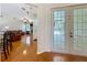 View of a living room with hardwood floors, a brick fireplace, and leather furniture at 5489 Glen Oak Place, Sanford, FL 32771
