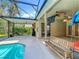 Backyard with a screened-in pool, lanai, ceiling fan, mounted TV, furniture, and a view of the interior at 5489 Glen Oak Place, Sanford, FL 32771