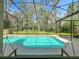 Inviting screened-in pool offers a private outdoor oasis for relaxation and recreation at 5489 Glen Oak Place, Sanford, FL 32771