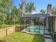 The backyard features a screened-in pool and green lawn with surrounding fence and mature trees at 5489 Glen Oak Place, Sanford, FL 32771
