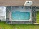 Aerial view of screened in pool with clear blue water and concrete perimeter surrounded by green grass and brown roof at 5489 Glen Oak Place, Sanford, FL 32771