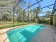 Backyard with a screened-in pool, lanai, and lush greenery at 5489 Glen Oak Place, Sanford, FL 32771