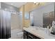 Bathroom with combined shower and tub, large vanity, and neutral decor at 654 Star Magnolia Dr, Kissimmee, FL 34744