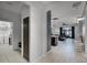 Bright hallway with access to the laundry room and an open view into the living room area at 654 Star Magnolia Dr, Kissimmee, FL 34744