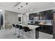 Open concept kitchen featuring an island with seating, stainless steel appliances, and stylish pendant lighting at 654 Star Magnolia Dr, Kissimmee, FL 34744