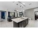 Open concept kitchen featuring an island with built-in wine cooler and open views to the living room at 654 Star Magnolia Dr, Kissimmee, FL 34744