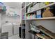 The laundry room offers shelving units and room for a washer and dryer at 654 Star Magnolia Dr, Kissimmee, FL 34744