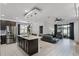 Open-concept living space featuring an island kitchen, a dining area, and a comfortable leather sofa at 654 Star Magnolia Dr, Kissimmee, FL 34744