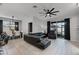 Open-concept living space with comfortable leather seating, modern light fixtures, and access to the patio at 654 Star Magnolia Dr, Kissimmee, FL 34744