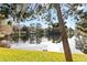 View of the community pond showcasing wildlife on a grassy area with views of neighborhood trees at 654 Star Magnolia Dr, Kissimmee, FL 34744