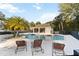 Community pool featuring a sun deck with lounge chairs and a covered area for community members at 654 Star Magnolia Dr, Kissimmee, FL 34744