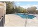 Outdoor community pool with a sun deck surrounded by a black metal fence with lounge chairs at 654 Star Magnolia Dr, Kissimmee, FL 34744