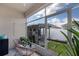 The screened patio includes an outdoor grilling kitchen and views of the backyard at 654 Star Magnolia Dr, Kissimmee, FL 34744