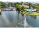 Scenic aerial view showcasing a fountain lake, wooden bridge, and community pool in a lush setting at 661 Hangnest Ln, Lake Mary, FL 32746