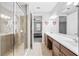 Bright bathroom with double sinks, tile flooring, a glass-enclosed shower and doorway to bedroom at 661 Hangnest Ln, Lake Mary, FL 32746