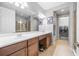 Bright bathroom featuring double sinks, tile floor, and a glass-enclosed shower at 661 Hangnest Ln, Lake Mary, FL 32746