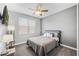 Cozy bedroom with large window for natural light and ceiling fan at 661 Hangnest Ln, Lake Mary, FL 32746