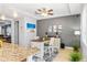 Bright dining area featuring a stylish table with white chairs, complemented by neutral walls and elegant decor at 661 Hangnest Ln, Lake Mary, FL 32746