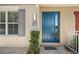 Welcoming townhouse entrance featuring a vibrant blue door and stone-paved walkway at 661 Hangnest Ln, Lake Mary, FL 32746