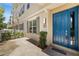 Eye-catching townhouse entrance showcasing a blue front door and neatly landscaped walkway at 661 Hangnest Ln, Lake Mary, FL 32746