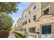 Well-maintained townhome exterior with neutral paint, a charming blue front door, and manicured landscaping at 661 Hangnest Ln, Lake Mary, FL 32746