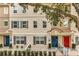 Charming townhouse exterior featuring neutral paint, grey shutters, and colorful front doors at 661 Hangnest Ln, Lake Mary, FL 32746