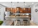 Well-lit kitchen featuring wood cabinetry, granite countertops, and stainless-steel appliances at 661 Hangnest Ln, Lake Mary, FL 32746