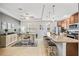 Open-concept kitchen with granite countertops, stainless steel appliances, and breakfast bar seating at 661 Hangnest Ln, Lake Mary, FL 32746