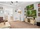 Open-concept living room, with wooden floors, leads into a combined dining area, providing an airy, connected living space at 661 Hangnest Ln, Lake Mary, FL 32746