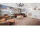 Comfortable living room showcasing plush furniture, a wooden coffee table, and tasteful decor, adjacent to the dining area at 661 Hangnest Ln, Lake Mary, FL 32746