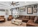 Inviting living room featuring a leather sectional sofa, a wooden coffee table, and tasteful wall decorations for relaxation at 661 Hangnest Ln, Lake Mary, FL 32746